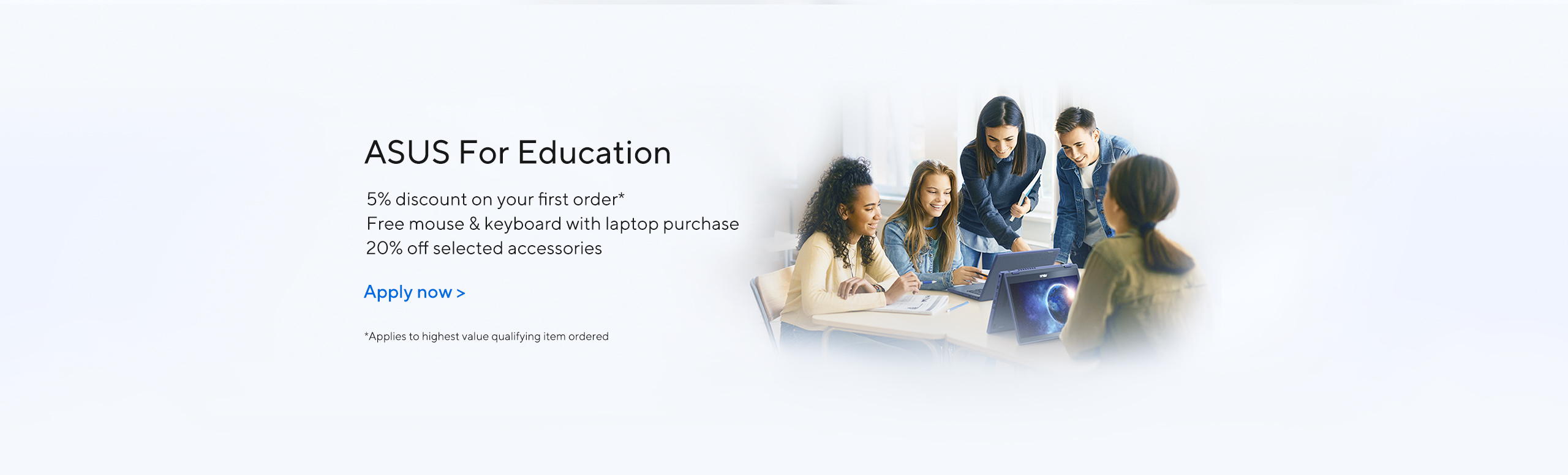 A group of students working on a pair of ASUS 2-in-1 laptops