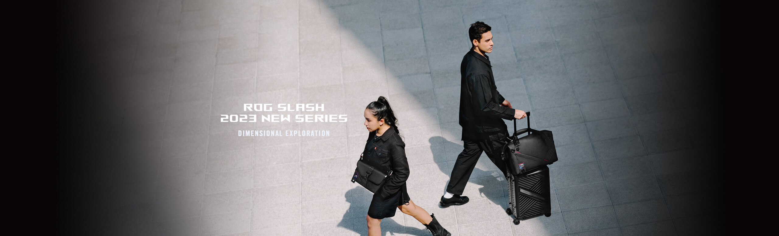 Two people passing each other on the street, with one using the ROG SLASH Sling Bag 2.0, and the other the ROG SLASH Hard Case Luggage and ROG SLASH Duffle Bag.