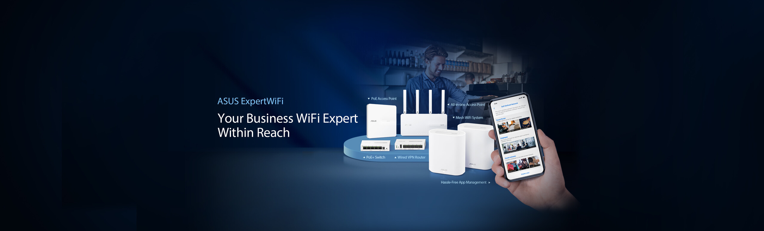 ASUS ExpertWiFi lineup in café setting with a hand holding phones showing the ExpertWiFi app UI. Rear row from left: EBA63 PoE AP, EBR63 all-in-one AP. Front: EBP15 POE+ switch, EBG15 wired VPN router, and two EBM68 mesh WiFi system.