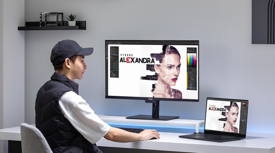 A professional photographer reviewing their work with a ProArt PC, ProArt monitor and ASUS accessories