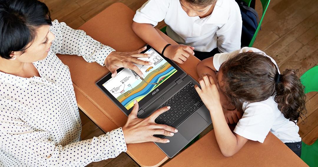Teacher shows two students an infographic on the ASUS BR1100C Laptop as part of the Pilot for the Fututre Program