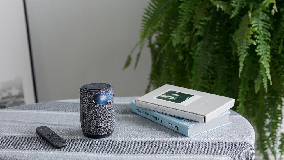 ASUS ZenBeam Latte L1 portable projector on a table projecting towards the camera